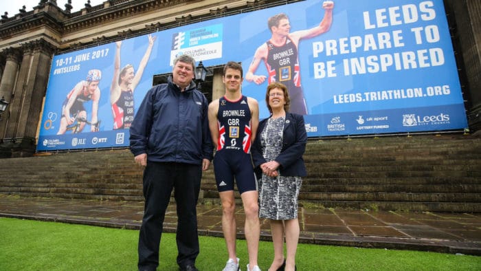Jonny Brownlee poses in front of Leeds Town Hall ahead of the Columbia Threadneedle World Triathlon Leeds with Wayne Coyle (event director) and Leeds councillor Judith Blake.on 10 & 11 June 2017. Barrington Coombs/PA Wire