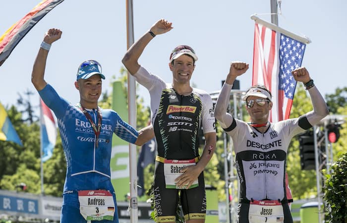 ROTH, GERMANY - JULY 01: (L-R) Andreas Dreitz from Germany, Sebastian Kienle of Germany and Jesse Thomas pose for a picture during the flower ceremony of the DATEV Challenge Roth 2018 on July 1, 2018 in Roth, Germany. (Photo by Jan Hetfleisch/Getty Images)