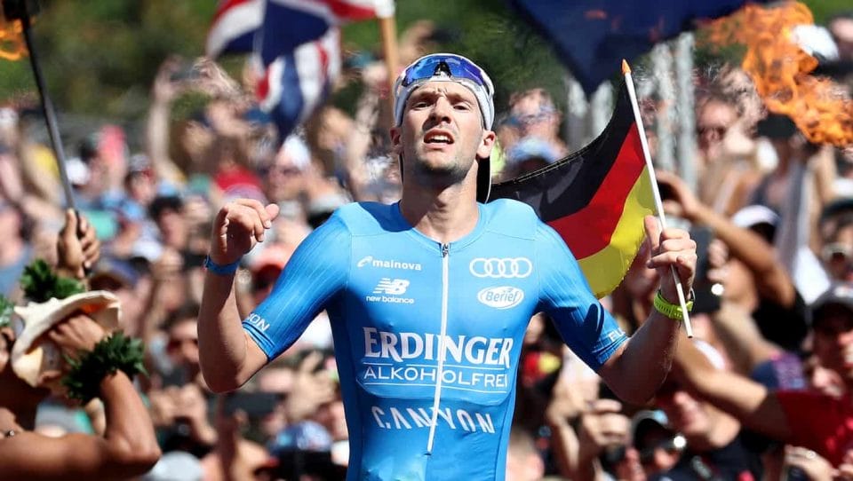 KAILUA KONA, HI - OCTOBER 13: Patrick Lange of Germany celebrates before he crosses the finish line and sets a course record of 7:52:39 to win the IRONMAN World Championships brought to you by Amazon on October 13, 2018 in Kailua Kona, Hawaii. (Photo by Al Bello/Getty Images for IRONMAN)