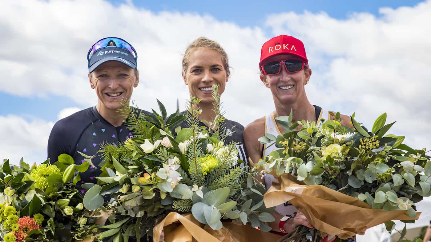 WANAKA, NEW ZEALAND - FEBRUARY 16: Women's podium at the 2019 Challenge Wanaka Half (L-R) Laura Siddall, UK in 3rd, Hannah Wells, NZ in 1st and Meredith Kessler, USA in 2nd. (Photo by Neil Kerr/Getty Images)