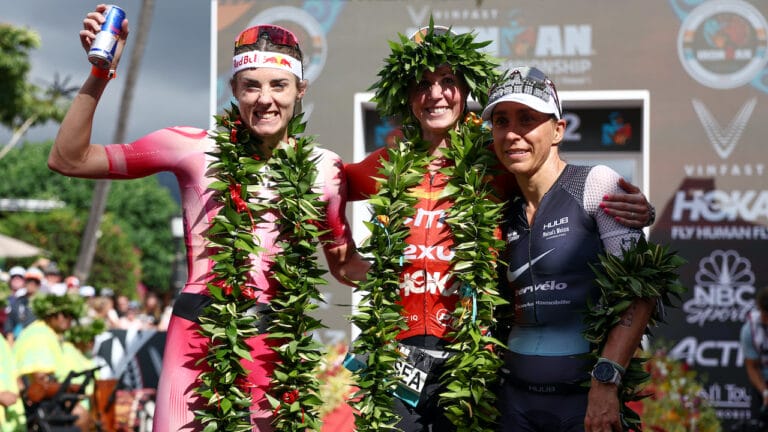 KAILUA KONA, HAWAII - OCTOBER 06: Lucy Charles-Barclay of Great Britain (2nd), Chelsea Sodaro (1st) and Anne Haug of Germany (3rd) celebrate after finishing the Ironman World Championships on October 06, 2022 in Kailua Kona, Hawaii. (Photo by Tom Pennington/Getty Images for IRONMAN)