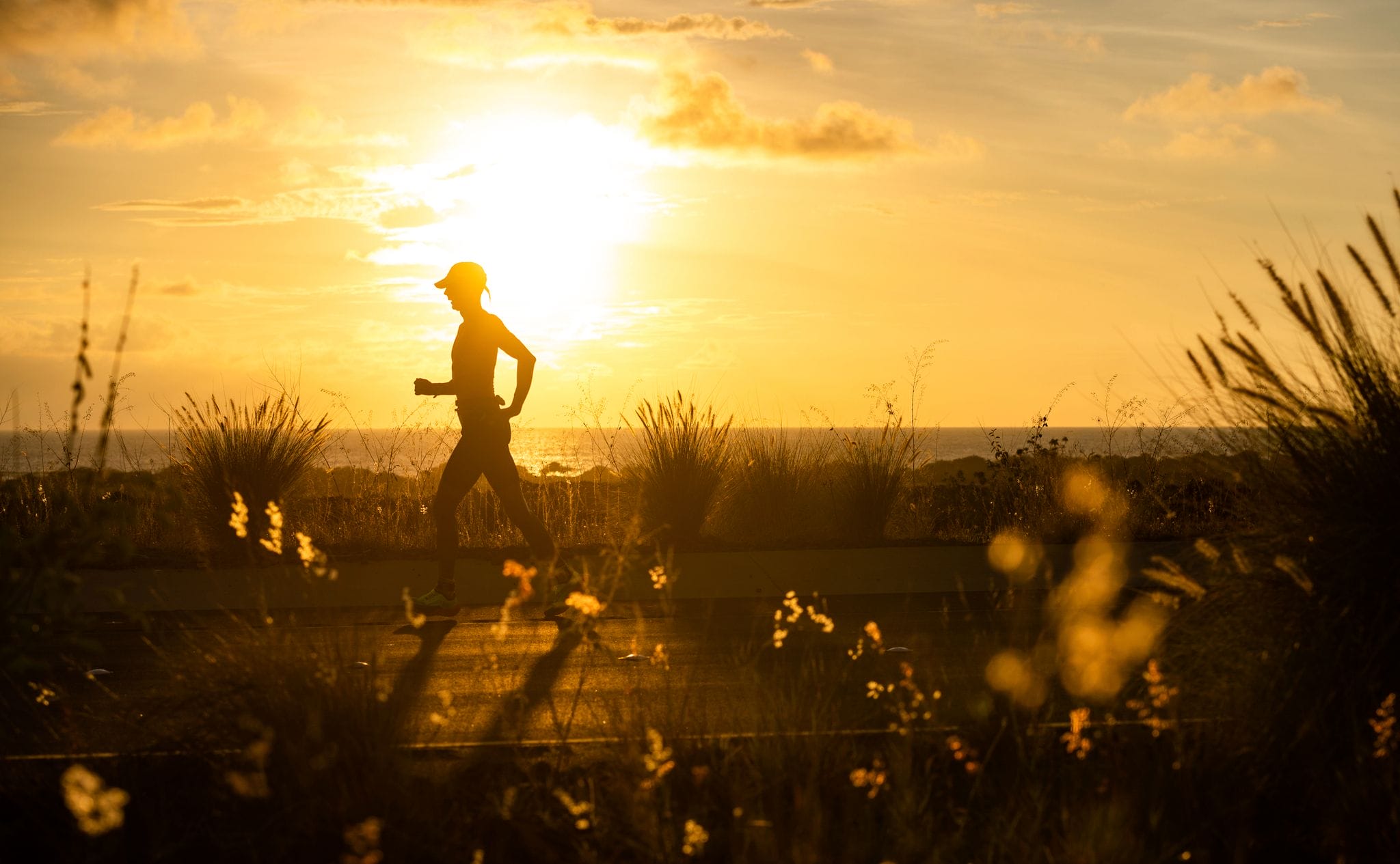 Runner on course at sunset at the Ironman World Championships in Kona.