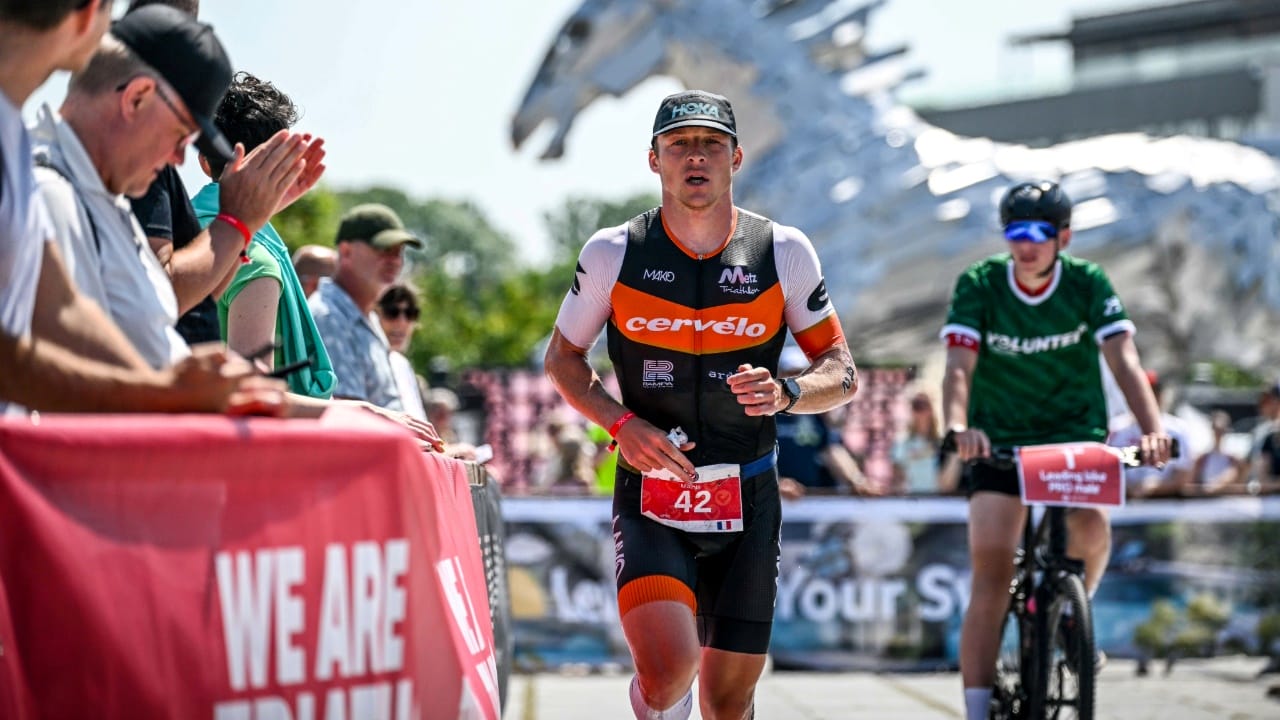 Challenge Samorin The Championship male pro triathlete and spectators on the run course