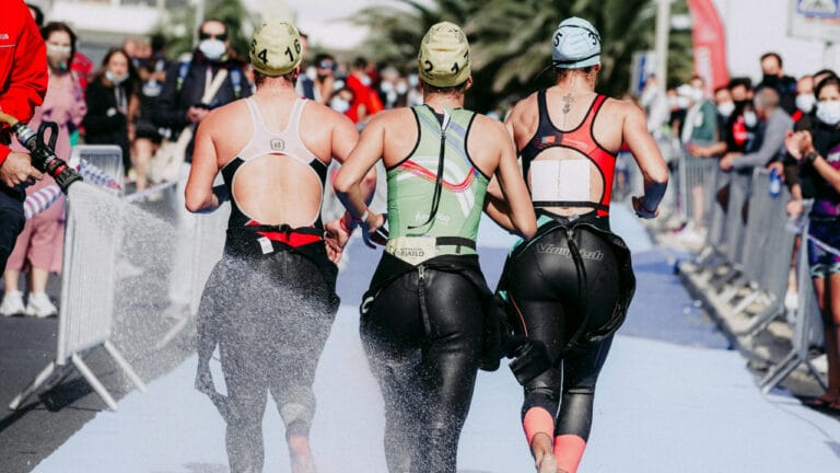 triathletes exiting water into t1