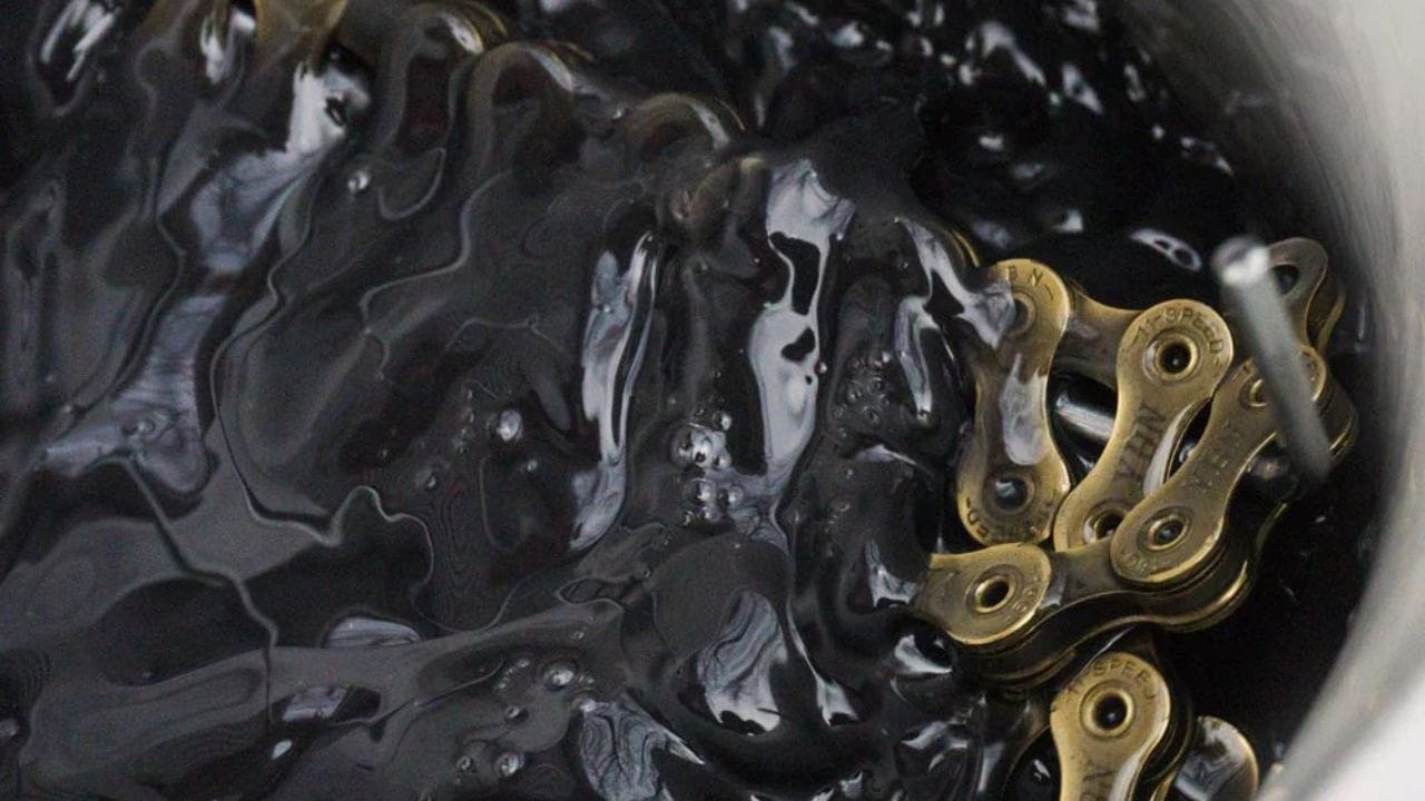 Chain being waxed in pot of chain wax