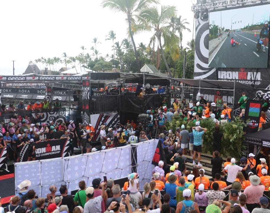 Taylor Knibb sat on road as crowd watch at finish of IRONMAN World Championship Kona 2025