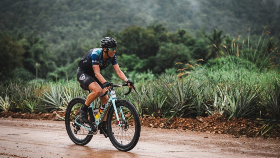 Caroline Livesey battles through the terrible conditions to win the recent UCI gravel event in Thailand. [Photo credit: UCI]